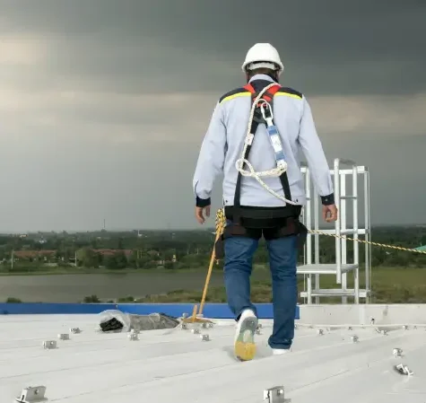 A commercial contractor walking the roof