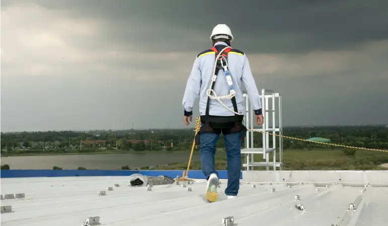 A commercial contractor walking the roof