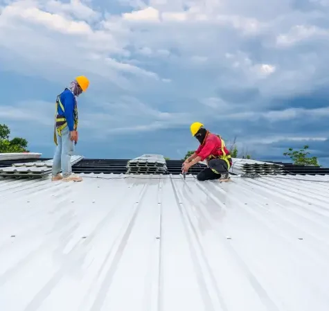 Two commercial experts on the roof doing repairs