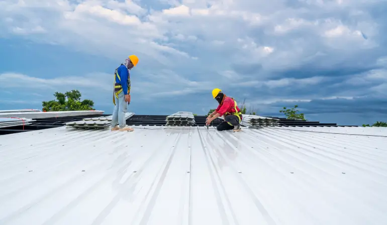 Two commercial experts on the roof doing repairs